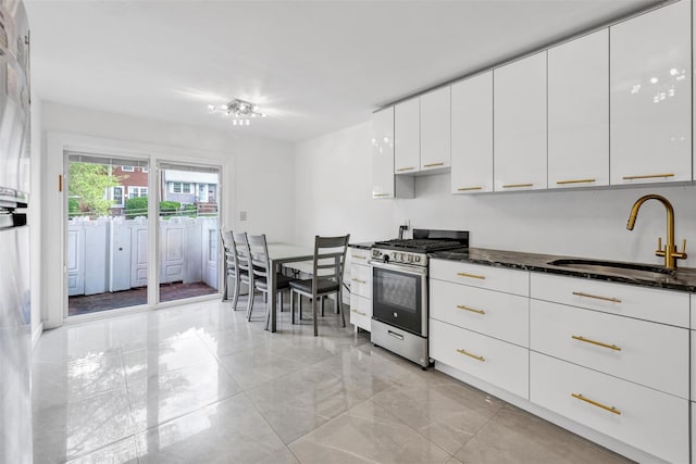 22 Sharon Dr, Spring Valley, NY 10977 - kitchen featuring gas stove, white cabinetry, modern cabinets, and dark stone countertops