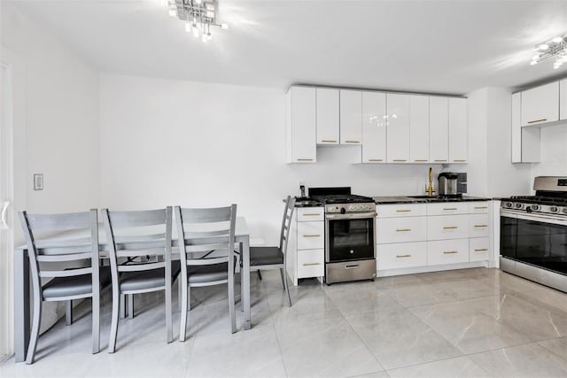 22 Sharon Dr, Spring Valley, NY 10977 - kitchen with stainless steel gas stove, modern cabinets, and dark countertops