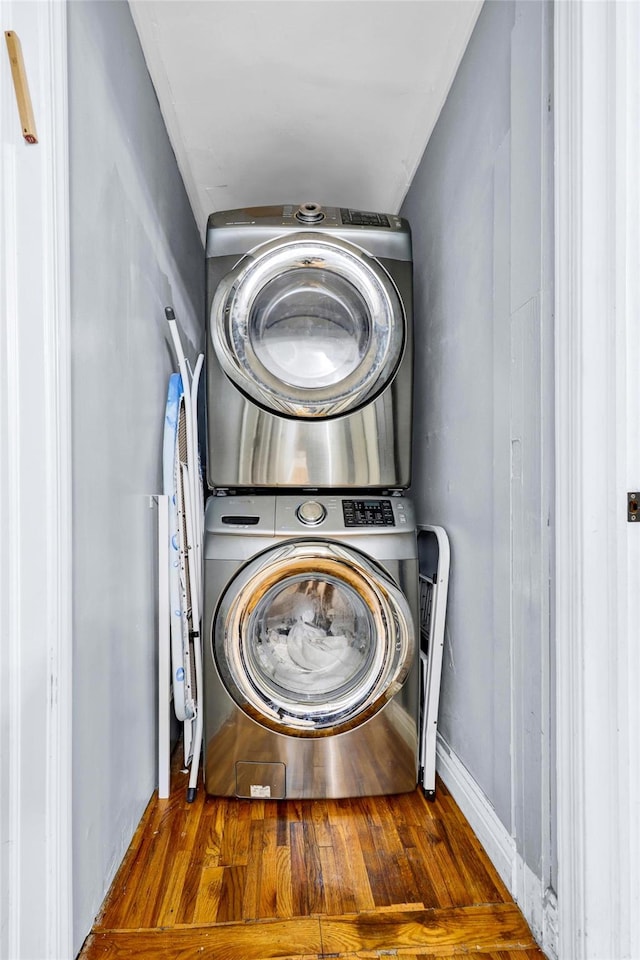 22 Sharon Dr, Spring Valley, NY 10977 - washroom with stacked washer and clothes dryer and wood finished floors