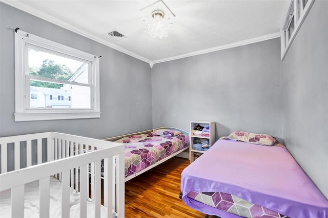 22 Sharon Dr, Spring Valley, NY 10977 - bedroom featuring ornamental molding and wood finished floors