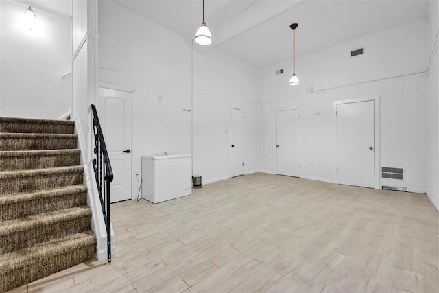 22 Sharon Dr, Spring Valley, NY 10977 - unfurnished living room with stairs and light wood-style flooring
