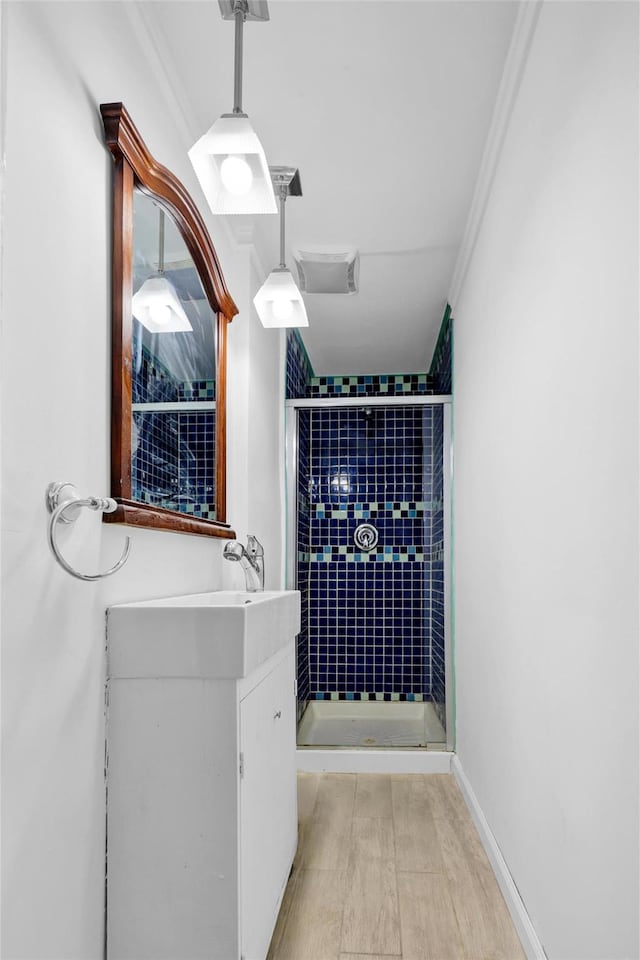 22 Sharon Dr, Spring Valley, NY 10977 - bathroom with a stall shower, crown molding, vanity, and wood finished floors