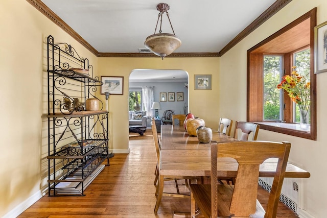 77 Nancy Blvd, Merrick, NY 11566 - dining area featuring arched walkways, wood finished floors, and ornamental molding