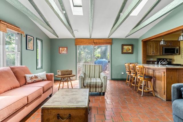 77 Nancy Blvd, Merrick, NY 11566 - living room featuring a skylight and baseboards