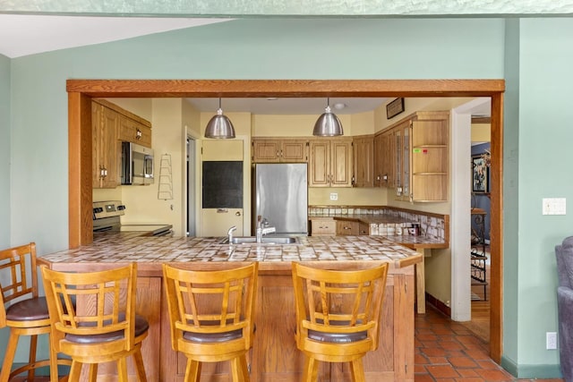 77 Nancy Blvd, Merrick, NY 11566 - kitchen featuring stainless steel appliances, a peninsula, tile counters, and pendant lighting