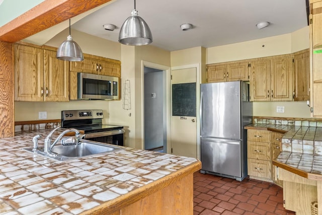 77 Nancy Blvd, Merrick, NY 11566 - kitchen featuring stainless steel appliances, tile counters, a peninsula, and hanging light fixtures