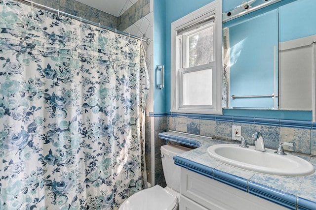 77 Nancy Blvd, Merrick, NY 11566 - full bathroom with vanity, tile walls, and a shower with shower curtain