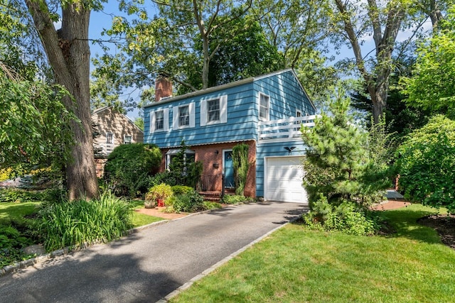 77 Nancy Blvd, Merrick, NY 11566 - colonial-style house with a chimney, driveway, brick siding, and a front lawn