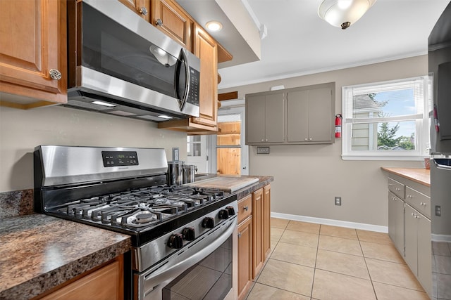 9 Grandview Ave, Middletown, NY 10940 - kitchen with stainless steel appliances, ornamental molding, dark countertops, gray cabinetry, and light tile patterned floors