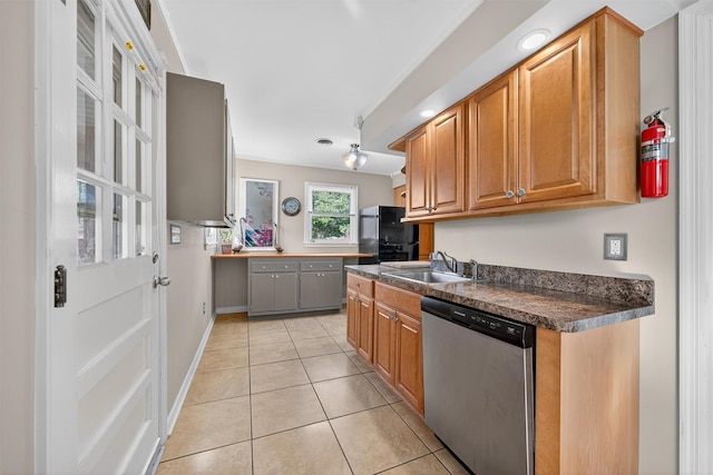 9 Grandview Ave, Middletown, NY 10940 - kitchen with dishwasher, freestanding refrigerator, dark countertops, light tile patterned floors, and brown cabinets