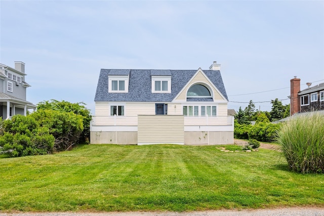10 Bayview Rd, Remsenburg, NY 11960 - rear view of house featuring a chimney, roof with shingles, and a lawn