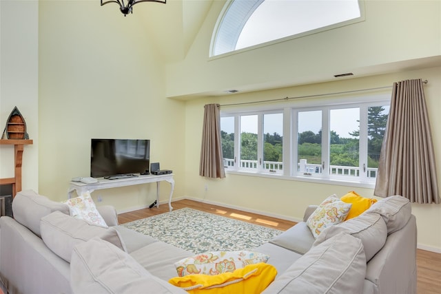 10 Bayview Rd, Remsenburg, NY 11960 - living area featuring healthy amount of natural light, wood finished floors, and a towering ceiling