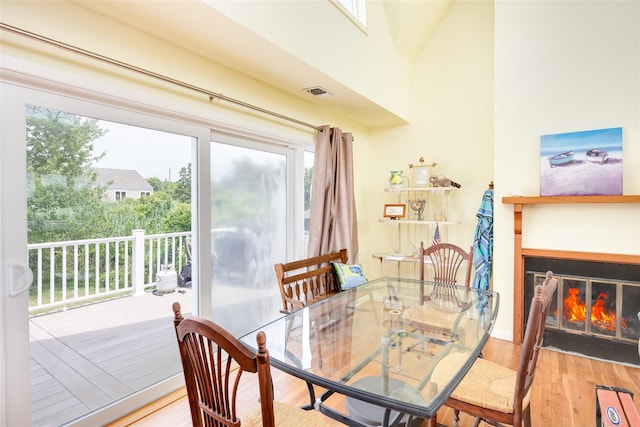 10 Bayview Rd, Remsenburg, NY 11960 - dining space featuring wood finished floors and a glass covered fireplace
