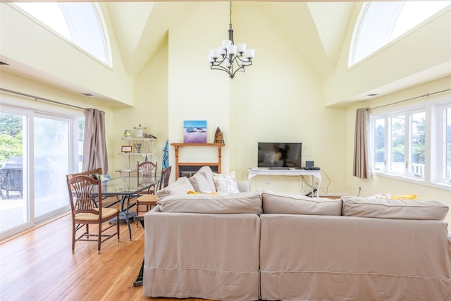 10 Bayview Rd, Remsenburg, NY 11960 - living room featuring a chandelier, light wood-style flooring, healthy amount of natural light, and high vaulted ceiling