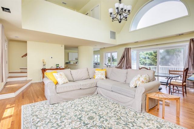 10 Bayview Rd, Remsenburg, NY 11960 - living area with light wood-style floors, a chandelier, and stairs