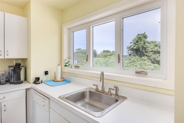 10 Bayview Rd, Remsenburg, NY 11960 - kitchen with white dishwasher, white cabinetry, light countertops, and healthy amount of natural light
