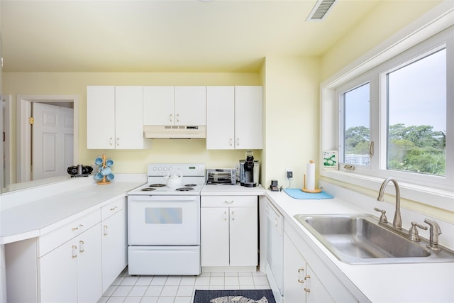 10 Bayview Rd, Remsenburg, NY 11960 - kitchen with under cabinet range hood, white appliances, white cabinets, light tile patterned floors, and light countertops
