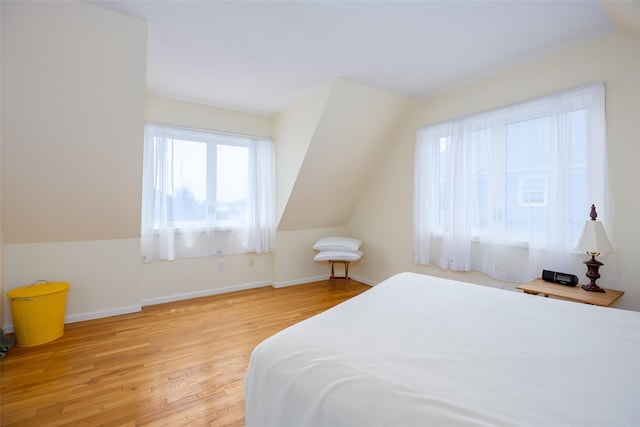 10 Bayview Rd, Remsenburg, NY 11960 - bedroom with multiple windows, light wood finished floors, and vaulted ceiling