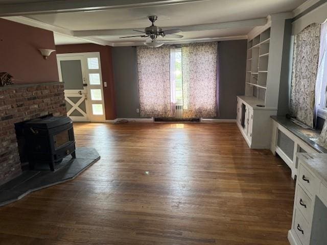 624 Adams Ave, Lindenhurst, NY 11757 - unfurnished living room featuring a wood stove, a ceiling fan, healthy amount of natural light, and wood finished floors
