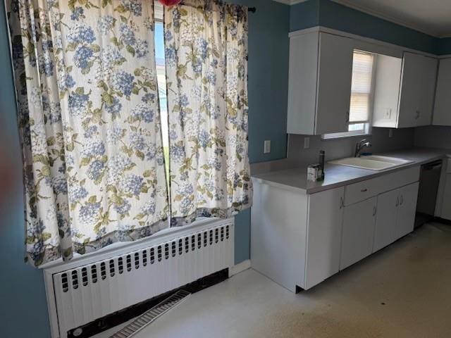 624 Adams Ave, Lindenhurst, NY 11757 - kitchen featuring radiator, dishwasher, light countertops, and white cabinets