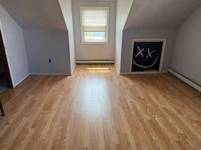 624 Adams Ave, Lindenhurst, NY 11757 - additional living space featuring light wood-style flooring and a baseboard radiator