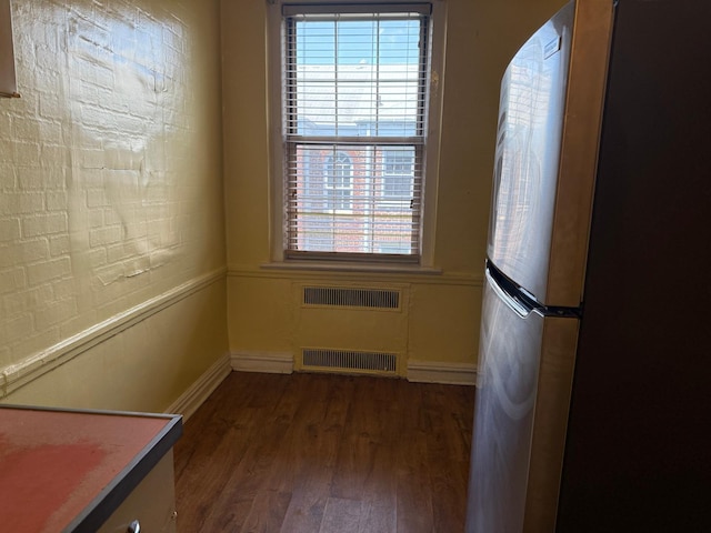 1 Meadow Dr Unit 3D, Woodmere, NY 11598 - unfurnished dining area featuring dark wood finished floors and radiator heating unit
