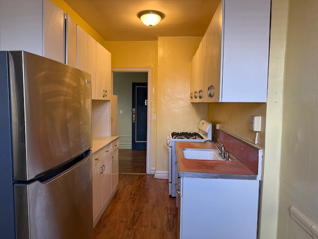1 Meadow Dr Unit 3D, Woodmere, NY 11598 - kitchen featuring freestanding refrigerator, gas range gas stove, white cabinetry, and dark wood finished floors