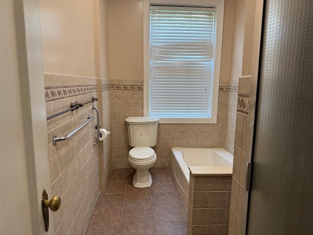 1 Meadow Dr Unit 3D, Woodmere, NY 11598 - bathroom with tile walls, tile patterned flooring, a garden tub, and a wainscoted wall