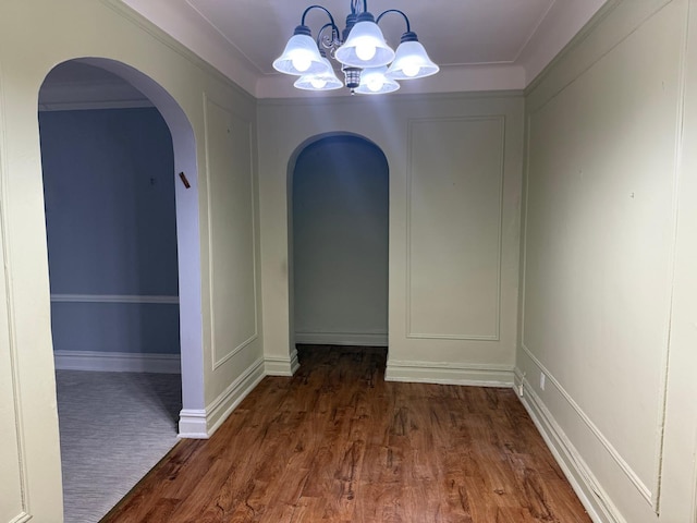1 Meadow Dr Unit 3D, Woodmere, NY 11598 - unfurnished dining area with arched walkways, a chandelier, and wood finished floors