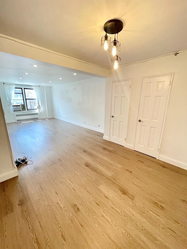 8385 116th St Unit 4B, Kew Gardens, NY 11418 - empty room with light wood finished floors and cooling unit