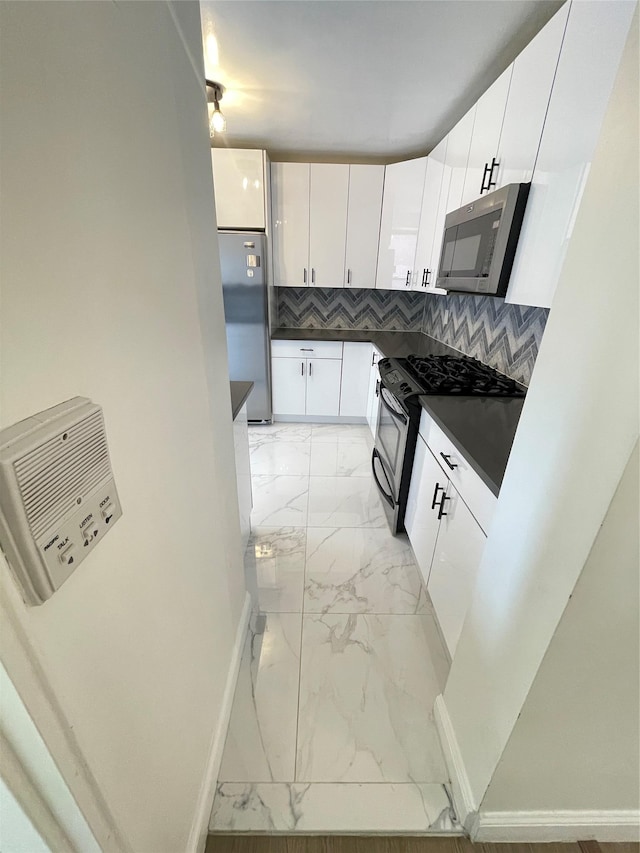 8385 116th St Unit 4B, Kew Gardens, NY 11418 - kitchen featuring appliances with stainless steel finishes, light marble finish floors, dark countertops, tasteful backsplash, and white cabinetry