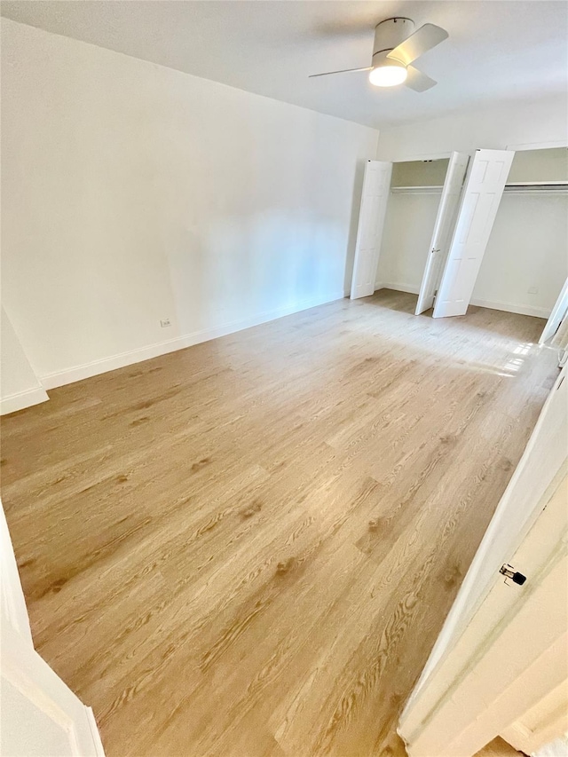 8385 116th St Unit 4B, Kew Gardens, NY 11418 - unfurnished bedroom featuring multiple closets, light wood finished floors, and ceiling fan