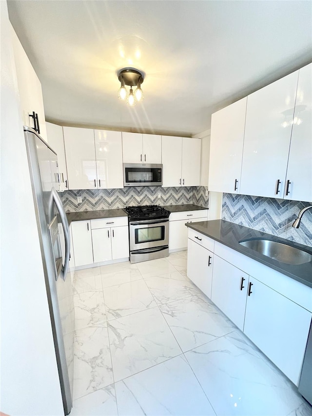 8385 116th St Unit 4B, Kew Gardens, NY 11418 - kitchen featuring appliances with stainless steel finishes, dark countertops, backsplash, and light marble finish flooring