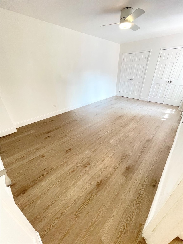 8385 116th St Unit 4B, Kew Gardens, NY 11418 - unfurnished bedroom featuring two closets, light wood-type flooring, and ceiling fan