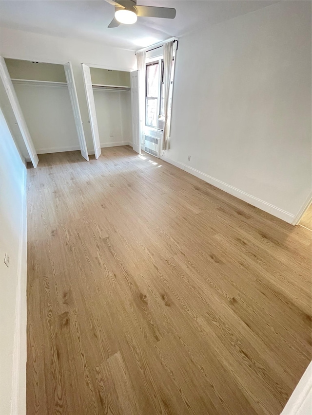 8385 116th St Unit 4B, Kew Gardens, NY 11418 - unfurnished bedroom featuring two closets, light wood finished floors, and ceiling fan