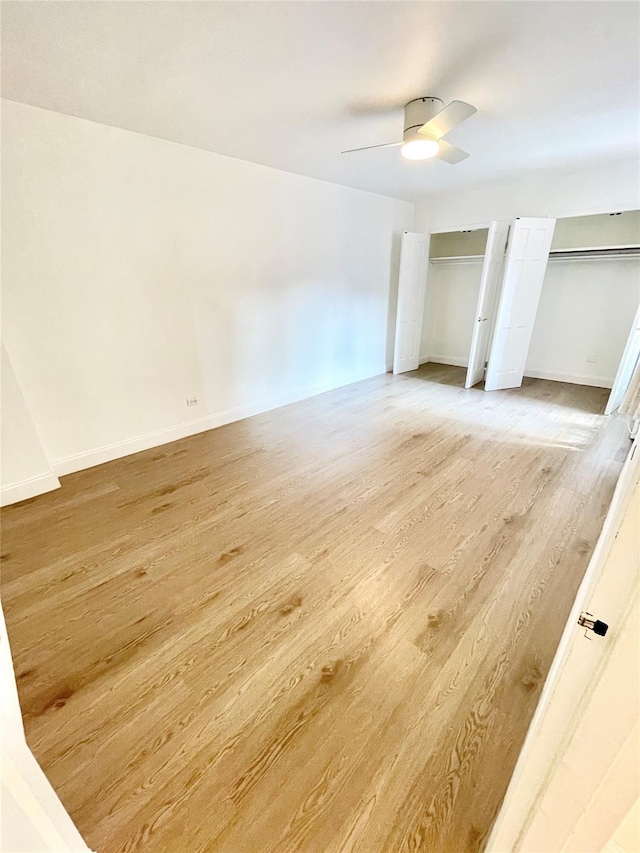 8385 116th St Unit 4B, Kew Gardens, NY 11418 - unfurnished bedroom with two closets, light wood-type flooring, and a ceiling fan