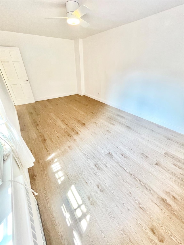 8385 116th St Unit 4B, Kew Gardens, NY 11418 - empty room featuring light wood-style flooring and a ceiling fan