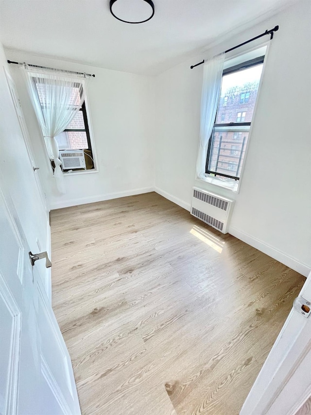 8385 116th St Unit 4B, Kew Gardens, NY 11418 - spare room featuring wood finished floors, plenty of natural light, and cooling unit