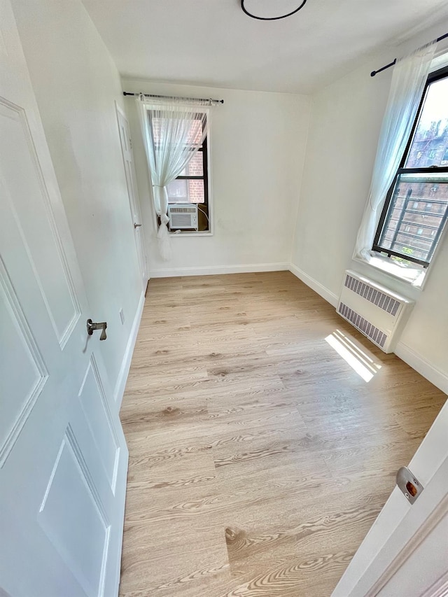 8385 116th St Unit 4B, Kew Gardens, NY 11418 - unfurnished room featuring plenty of natural light, wood finished floors, and cooling unit