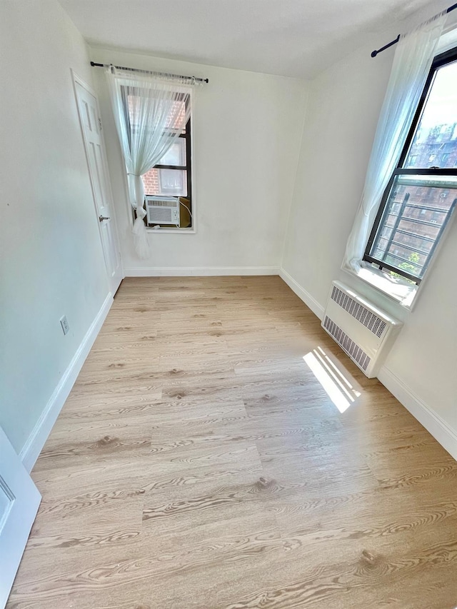 8385 116th St Unit 4B, Kew Gardens, NY 11418 - spare room with healthy amount of natural light, wood finished floors, and cooling unit