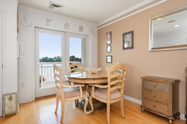600 Clarence Ave Unit 1J, Bronx, NY 10465 - dining room featuring light wood finished floors and ornamental molding
