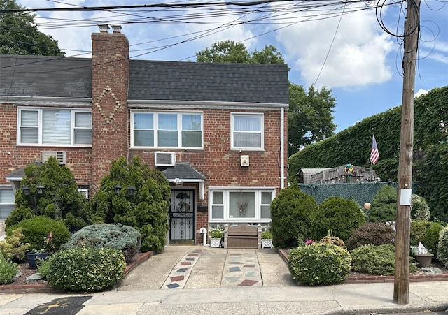 60-23 60th Rd, Maspeth, NY 11378 - multi unit property with brick siding, a chimney, and roof with shingles