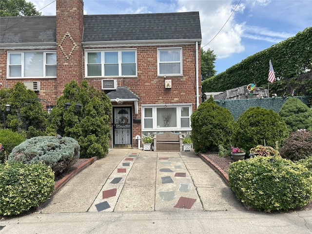 60-23 60th Rd, Maspeth, NY 11378 - view of front facade featuring a shingled roof, brick siding, and a chimney