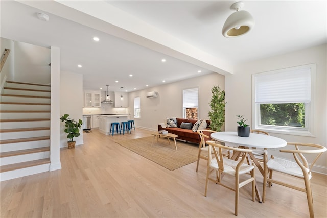 1 Saunders St, Hastings-On-Hudson, NY 10706 - dining space featuring a wall mounted AC, light wood finished floors, stairway, and recessed lighting