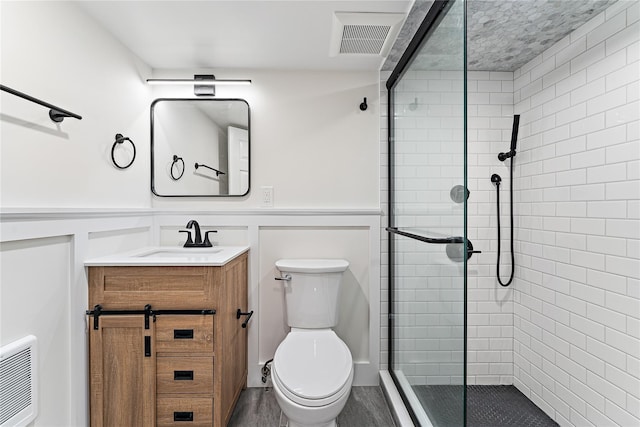 1 Saunders St, Hastings-On-Hudson, NY 10706 - full bathroom featuring a stall shower, vanity, wainscoting, and a decorative wall