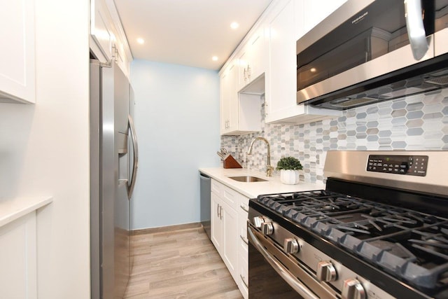 101 Lincoln Ave Unit 3K, Mineola, NY 11501 - kitchen with stainless steel appliances, white cabinets, light countertops, tasteful backsplash, and recessed lighting