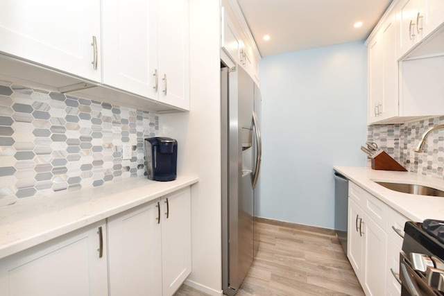 101 Lincoln Ave Unit 3K, Mineola, NY 11501 - kitchen with appliances with stainless steel finishes, tasteful backsplash, white cabinets, and recessed lighting