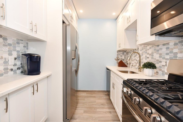 101 Lincoln Ave Unit 3K, Mineola, NY 11501 - kitchen with stainless steel appliances, tasteful backsplash, white cabinets, light wood-style floors, and recessed lighting