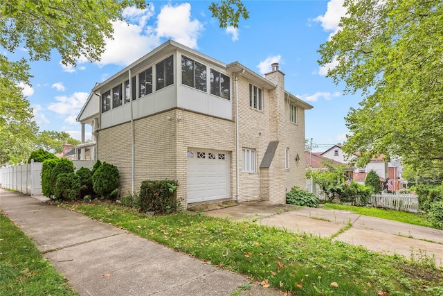 154-70 11th Ave, Beechhurst, NY 11357 - view of property exterior featuring brick siding, a chimney, a sunroom, and an attached garage