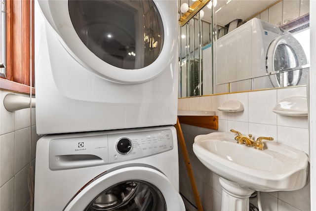 154-70 11th Ave, Beechhurst, NY 11357 - washroom featuring tile walls and stacked washer and clothes dryer
